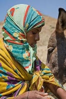 Saho woman resting with her donkey after a long journey